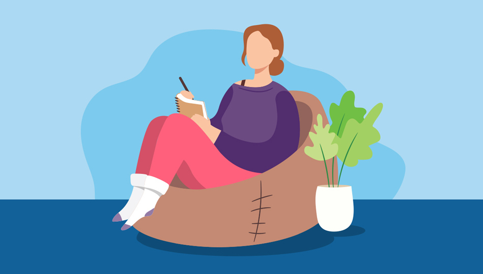 A woman sits in a bean bag chair writing notes in her notebook.