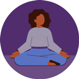 A woman sits cross-legged while practicing deep breathing exercises.