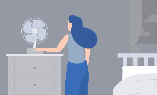 A woman turns a bedside fan on to provide a white noise.
