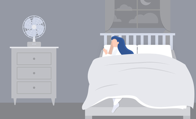 A woman sleeps comfortably in her bed.