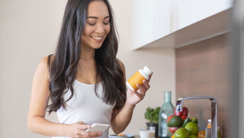 A woman takes her daily vitamin D supplement.