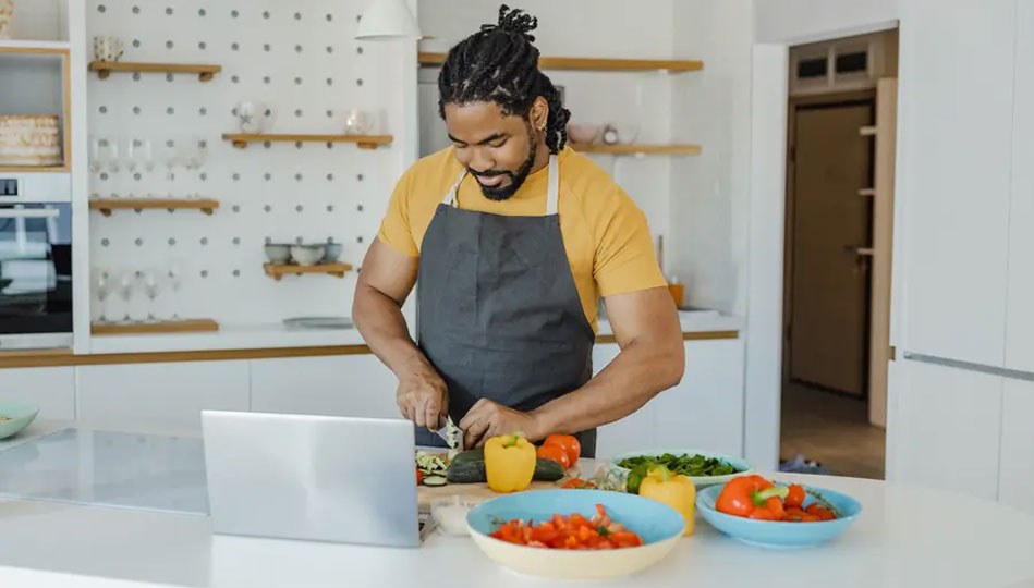 Person cooking with plants.