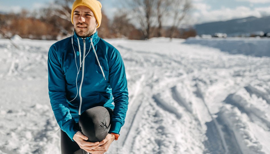 A man goes for a careful run during the winter months.