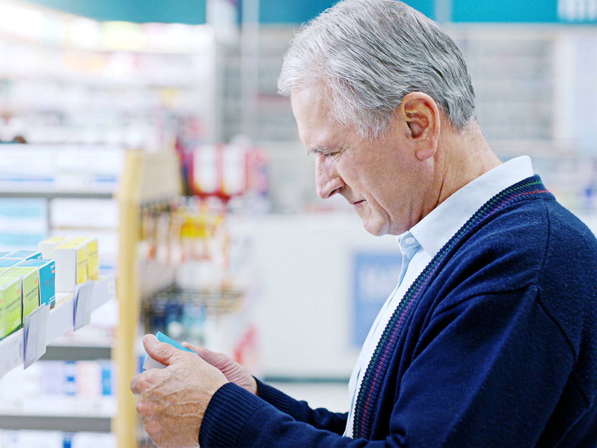 Man looking at the shelves in the pharmacy.