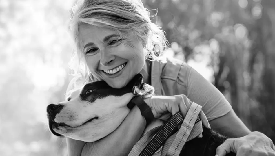 Smiling woman with cute dog.