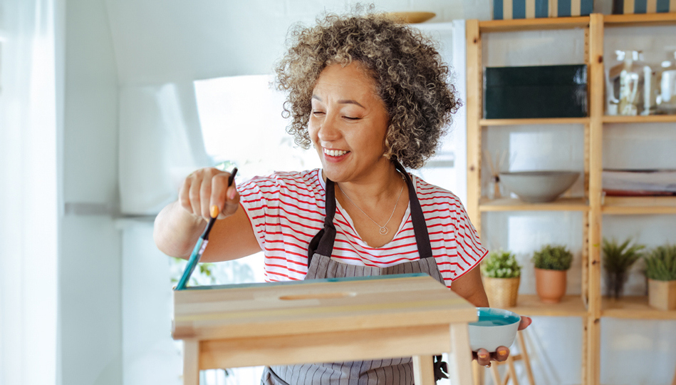 A woman takes time to indulge in her painting hobby.