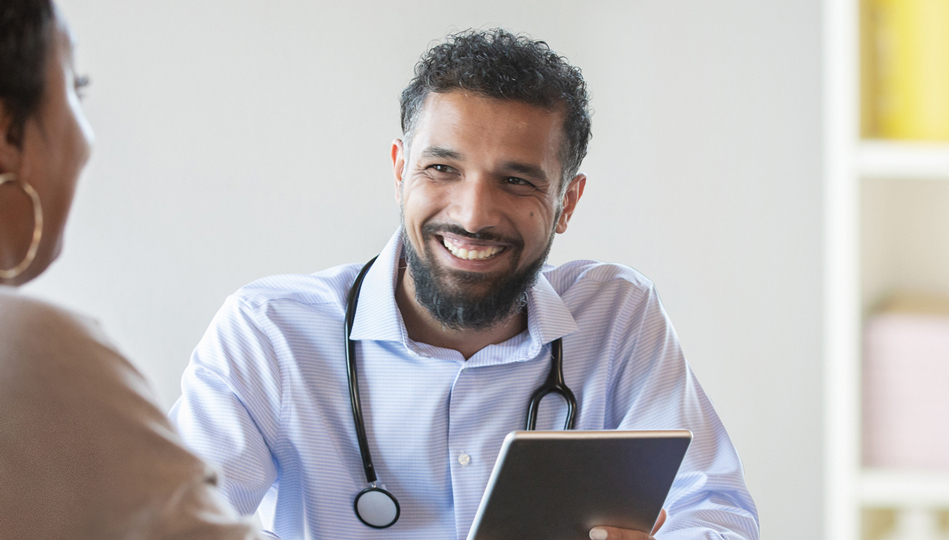 A woman asks her provider questions from her premade list.