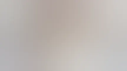 Three mason jars of overnight oats topped with raspberries and blueberries