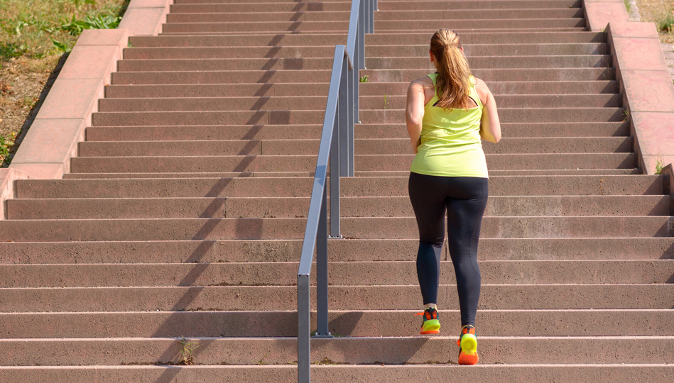 A woman goes for a jog up a set of urban steps to fight the afternoon energy slump.