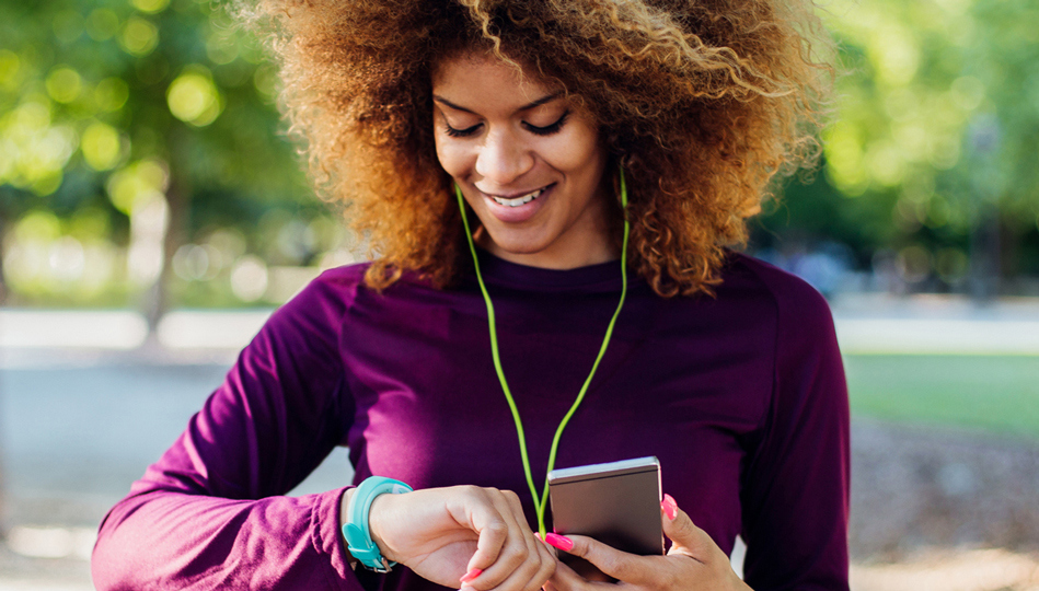 A woman uses her smart watch to track her daily movements to reach her goal.