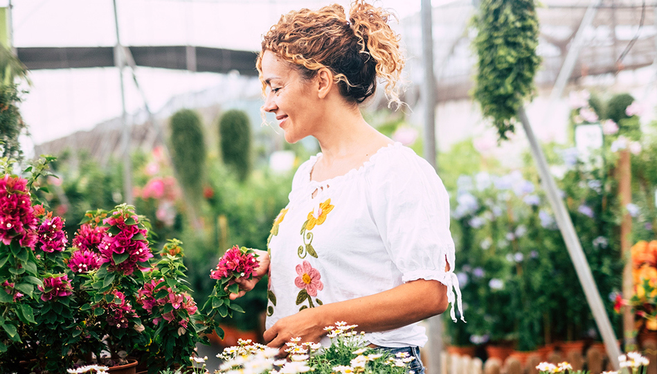 A woman enjoying a conservatory.